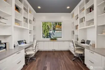 Just off the foyer is this custom office equipped with dual workstations and ample built-in storage.