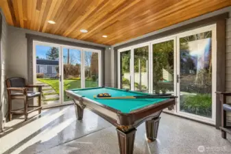 The indoor/outdoor flex room features glass doors that fold away to create an open air patio.