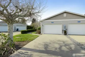 Spacious one car garage with additional parking space in driveway.