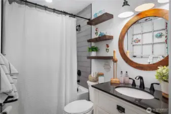 Full bath with beautifully tiled shower and quart countertops.