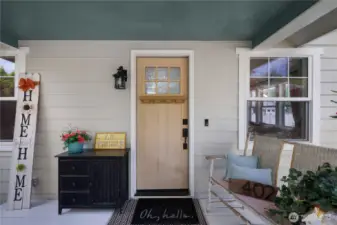Sweet covered porch and new door ready for you to paint it your favorite color.