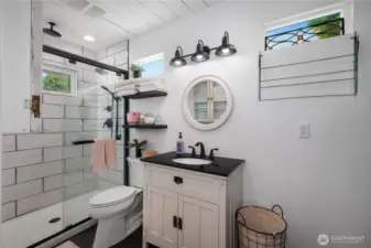 Another view of the bathroom, with shiplap ceilings and thoughtfully placed windows.