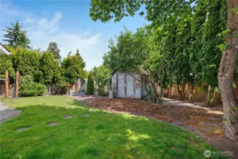 Plenty of privacy trees and a garden shed for all of your supplies.