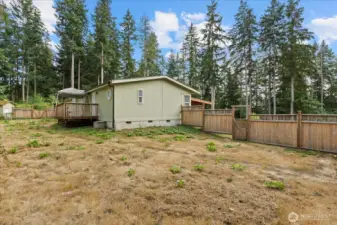 Back yard fence has a double door and a single door.