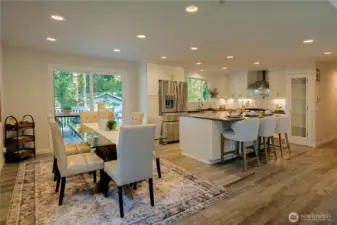 Elegant great room with dining area and kitchen with oversize island and bar seating.