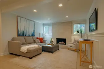 Lower level rec room with fireplace