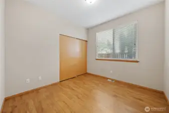 Bedroom 2 with wall-to-wall closet.  Window looks out to the side yard.
