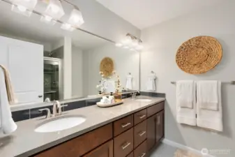 Primary ensuite with walk in shower,  double vanities, ample storage and counterspace.