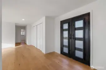 Heavy duty front doors welcome you. Down the hall are the bedrooms.