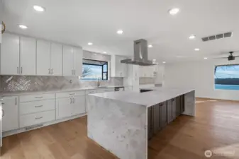 You'll enjoy this luxurious waterfall island counter as the cohesive color-tones flow seamlessly, naturally drawing the eye to the kitchen’s centerpiece!