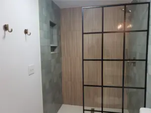 Another view of the 3/4 bath near the living room, with its exquisite tile and bamboo-look shower!