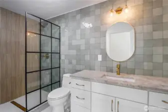 Did you say WOW!? And this is just the first of three upper end bathrooms! Once purely functional, this bathroom has been transformed with high-end finishes, a statement shower, and refined lighting and tile that elevate the entire space.