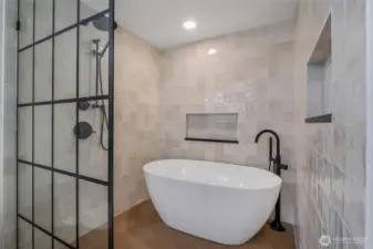 The remodeled fully tiled, primary bath features a deep, free-standing soaking tub, and an expansive shower with an adjustable shower head, your own spa! Now all you need is a massage!