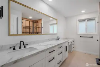This beautifully remodeled third bathroom showcases a dual vanity, designer finishes, and a high-end shower for an elevated everyday experience!  Nothing but the best for YOU!