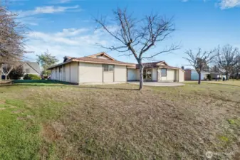 When spring comes, enjoy the back patio, and when the trees begin to leaf out, and the grass seeds sprout, you'll have a nice amount of shade in this backyard that flows gently to the lake.