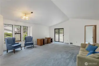 Space for a dining table below the hanging light. Slider out to the deck.