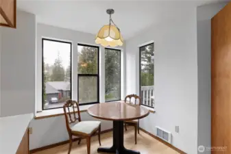 Casual dining space in front of the windows.