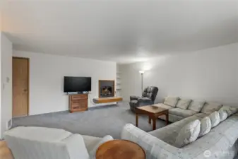 The 2nd living room has a wood burning fireplace. The door on the left is the staircase leading down to the garage.