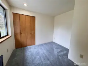 This is the 3rd bedroom used most likely as a bedroom with a twin bed or use as an office. Brand new carpet just installed.