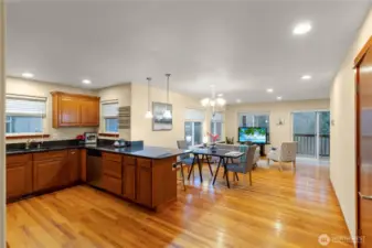 Generous kitchen peninsula provides extra prep space and seating while keeping the cook connected to the dining and living areas. Recessed lighting and hardwood floors add warmth throughout the main level.