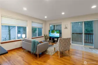 Spacious gathering area offers plenty of room for seating while enjoying views of the surrounding greenery. Large windows keep the space light and inviting throughout the day.