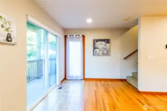 Sliding glass doors lead from the main living space to the covered back deck, creating an easy connection to outdoor living and the surrounding greenery.