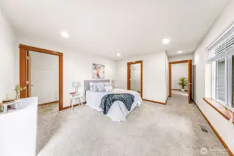 Generous primary bedroom offers plenty of space for a sitting area, with a walk-in closet and private en-suite bathroom nearby for everyday comfort.
