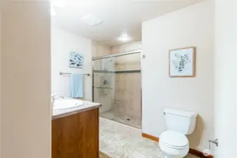 Primary bathroom with walk-in shower featuring tile surround and glass enclosure.