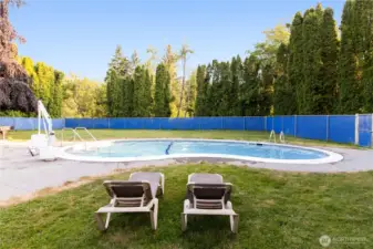 Second community pool offering a quieter setting surrounded by trees.