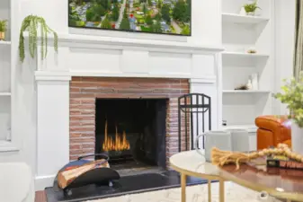 A cozy fireplace anchors the room, making it equally suited for quiet mornings or relaxed evenings.
