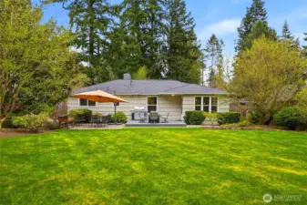 Statement trees anchor the space, while vibrant flowering shrubs bring color and fragrance you can actually experience. The expansive lawn offers room to play, relax, or simply enjoy the setting. Irrigation keeps everything thriving with ease.