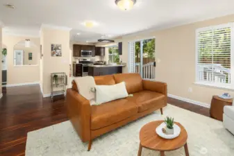 Showing hallway to left, going towards the front door, Family room, and Stairwell. To the right sliding patio door to deck and backyard