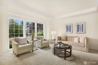As you enter the home, you are greeted with a large (this picture doesn't capture the whole room) formal living room with recessed ceiling and crown molding.