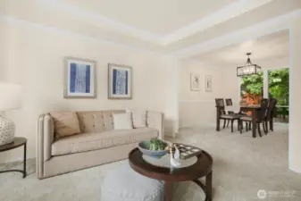 Adjacent to the living room is the formal dining room with a chair rail architectural detail and new dining chandelier.