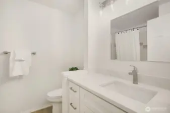 Full Bathroom on the Upper floor has a tub/shower, new flooring, new vanity with Quartz counter and new light fixture.  So fresh!