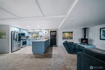 Open to the living and dining areas, this spacious kitchen with bar will be the hub and gathering spot