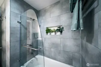 Custom glass enclosure opens up to fully use the tub to bathe a child, etc