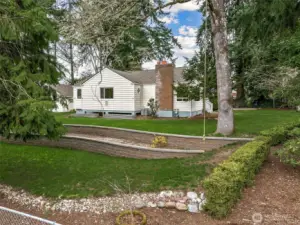 Private, park-like setting true to the charm found in this neighborhood, with mature heirloom trees and established rhododendron hedges.