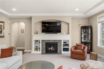 Facing fireplace with view of built-in bookcases