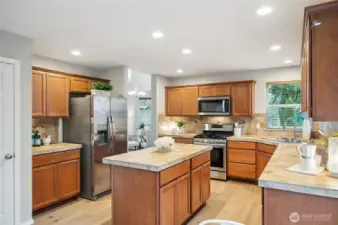 Open kitchen with plentiful cabinetry and a center island.