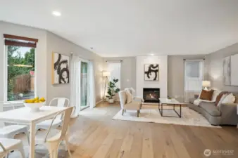 Wide plank flooring flows seamless throughout the kitchen, casual dining area, and the family room.