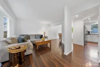 Looking in from front door: Living Room on left, flows into dining at far left, flows into kitchen on far right