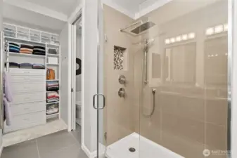 Separate commode and double shower heads. There is also a seat in the shower.