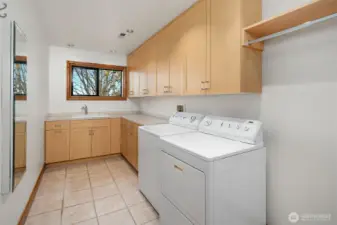 Large Laundry room between Primary bedroom and 2nd and 3rd bedrooms.