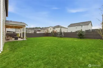 Large fenced backyard with separate dog run area.
