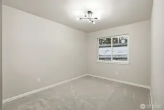 Second bedroom featuring large window and bright, open feel