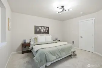 Comfortable primary bedroom featuring plush carpet and bright, airy feel