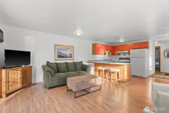 Vinyl plank flooring runs throughout the great room, creating an open, spacious feel, with kitchen counter seating providing a convenient informal dining option.