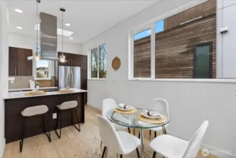 Big windows, light floors and modern finishes found in the gorgeous dining/kitchen space.