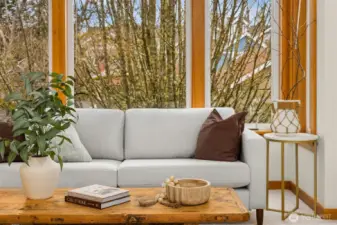 The living room looks out to the trees lining Winslow Way W.